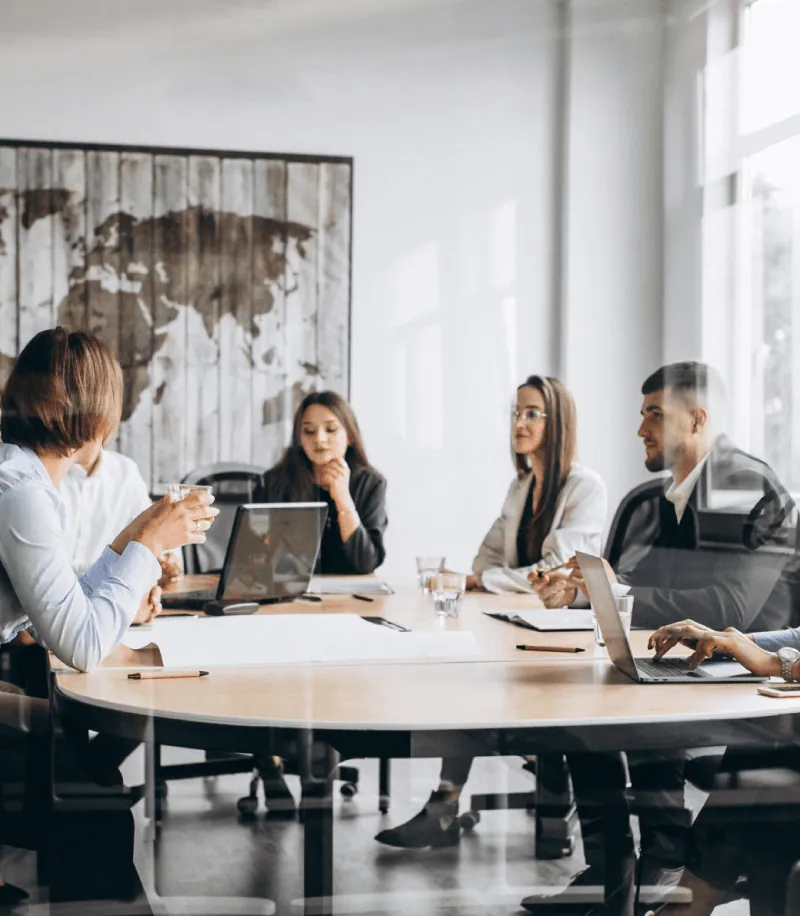 An agency team meeting around a conference table