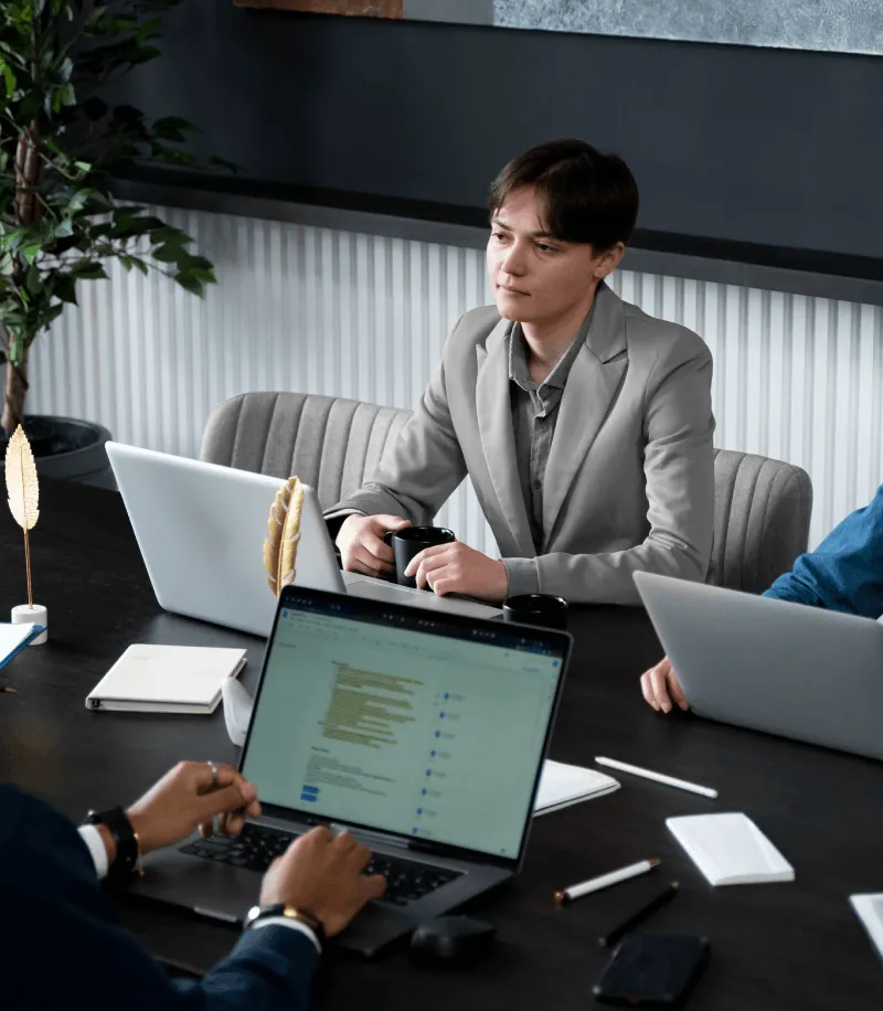 A business team working on laptops in a meeting room