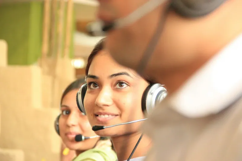 A support agent with a headset helping a customer