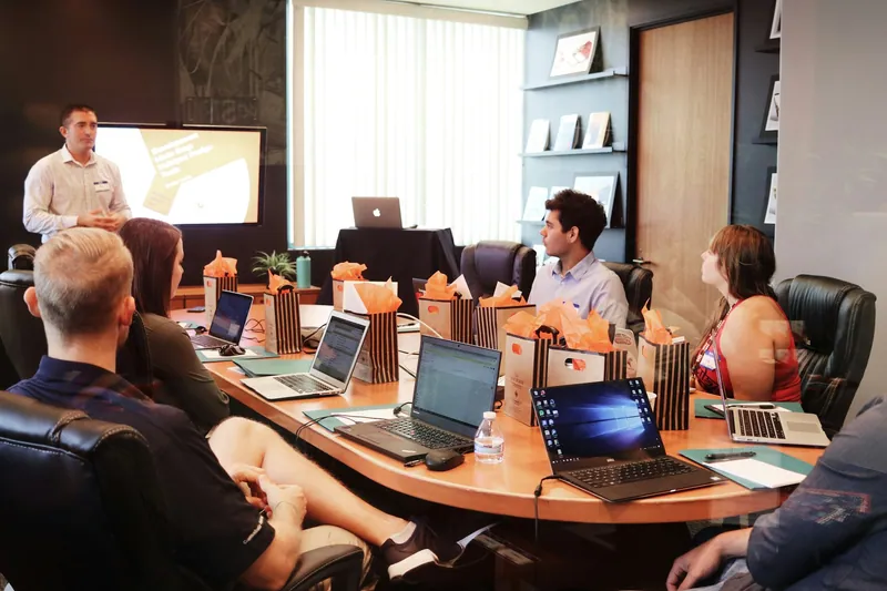 A sales team in a meeting reviewing a presentation